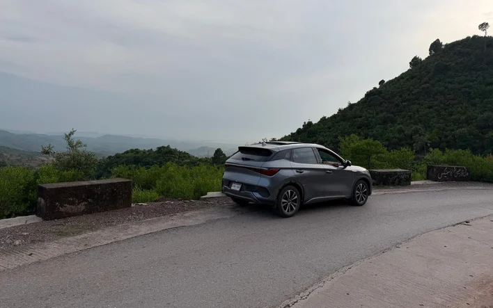 The BYD Atto 3 pulled over on a winding hill road on the way up to Murree