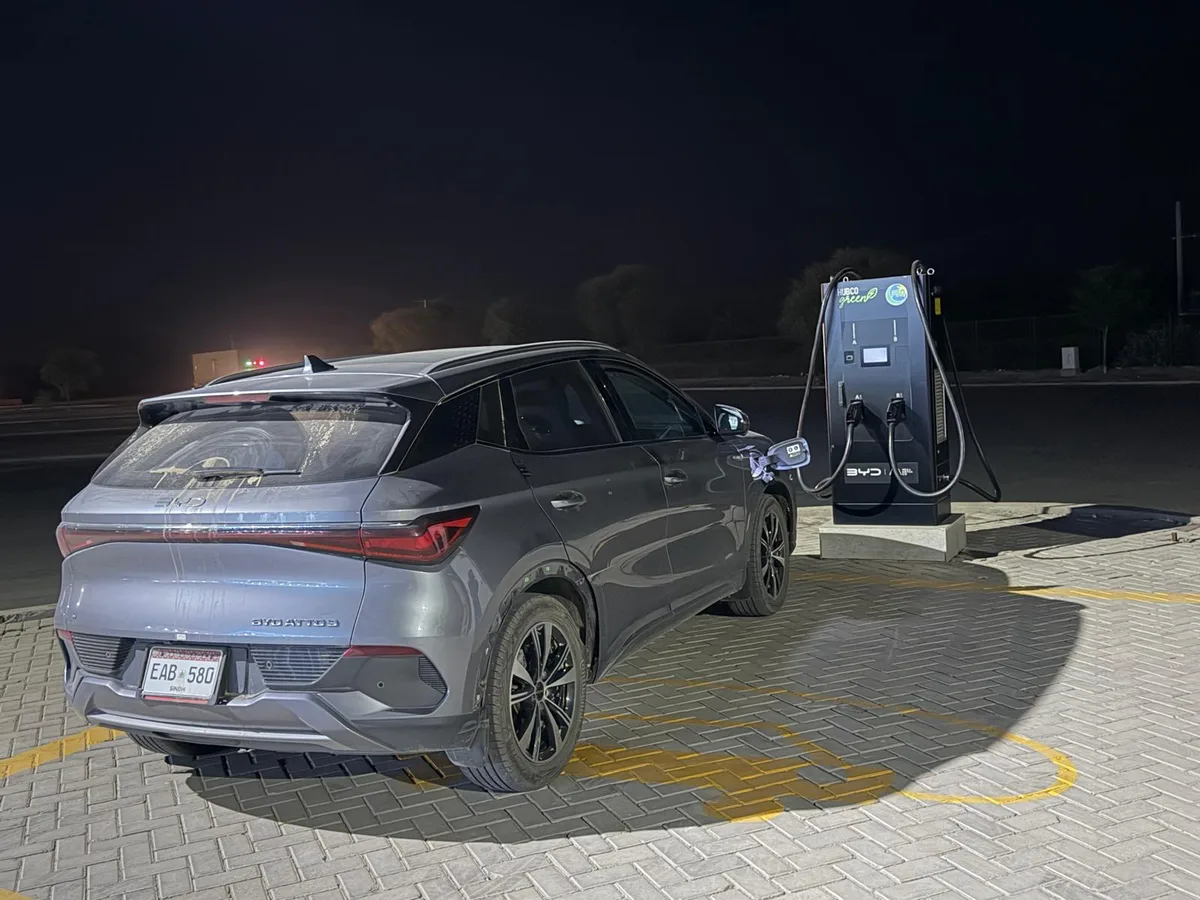 The Atto 3 charging alone at the Zahir Pir service area late at night