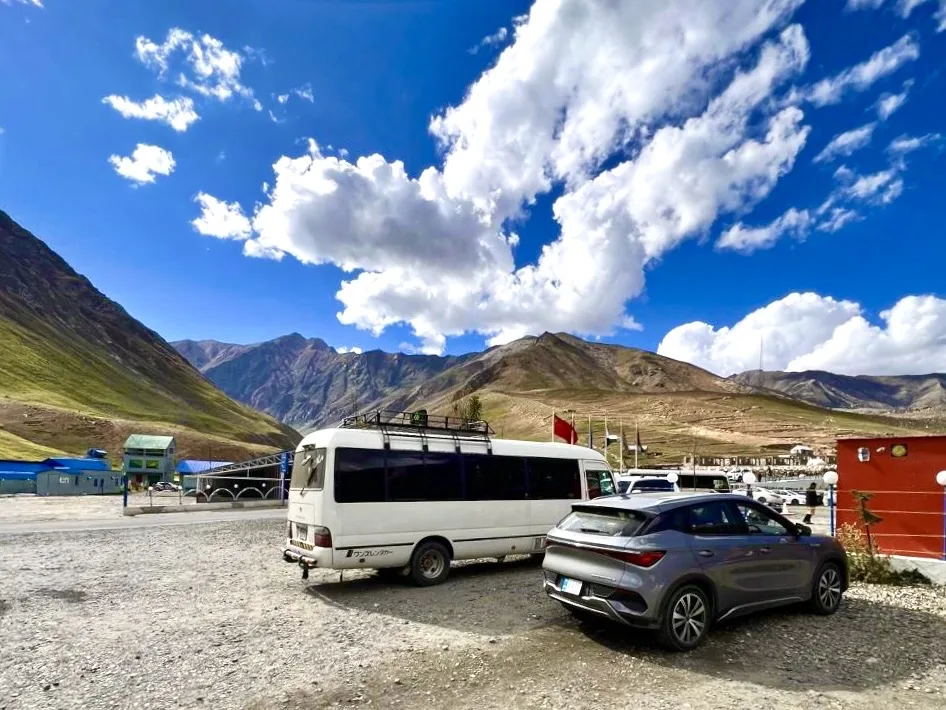 A silver BYD Atto 3 parked at a high altitude stop near Babusar Top