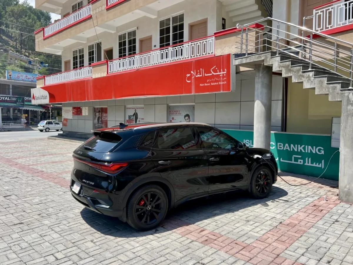 A black BYD Atto 3 charging at the Balakot EV Hub on the main bazaar