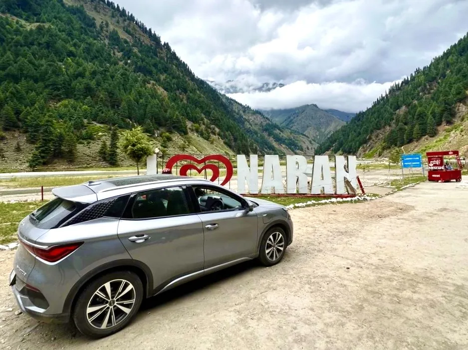 A silver BYD Atto 3 at the I love Naran sign in the Kaghan Valley