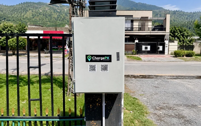 A ChargePK Host charger box with app QR codes at a host home