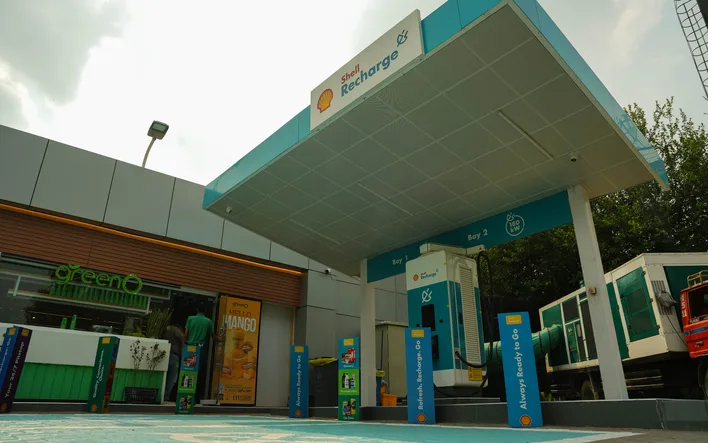 Twin DC fast charging bays under a Shell Recharge canopy at a Go Green fuel station site in Pakistan