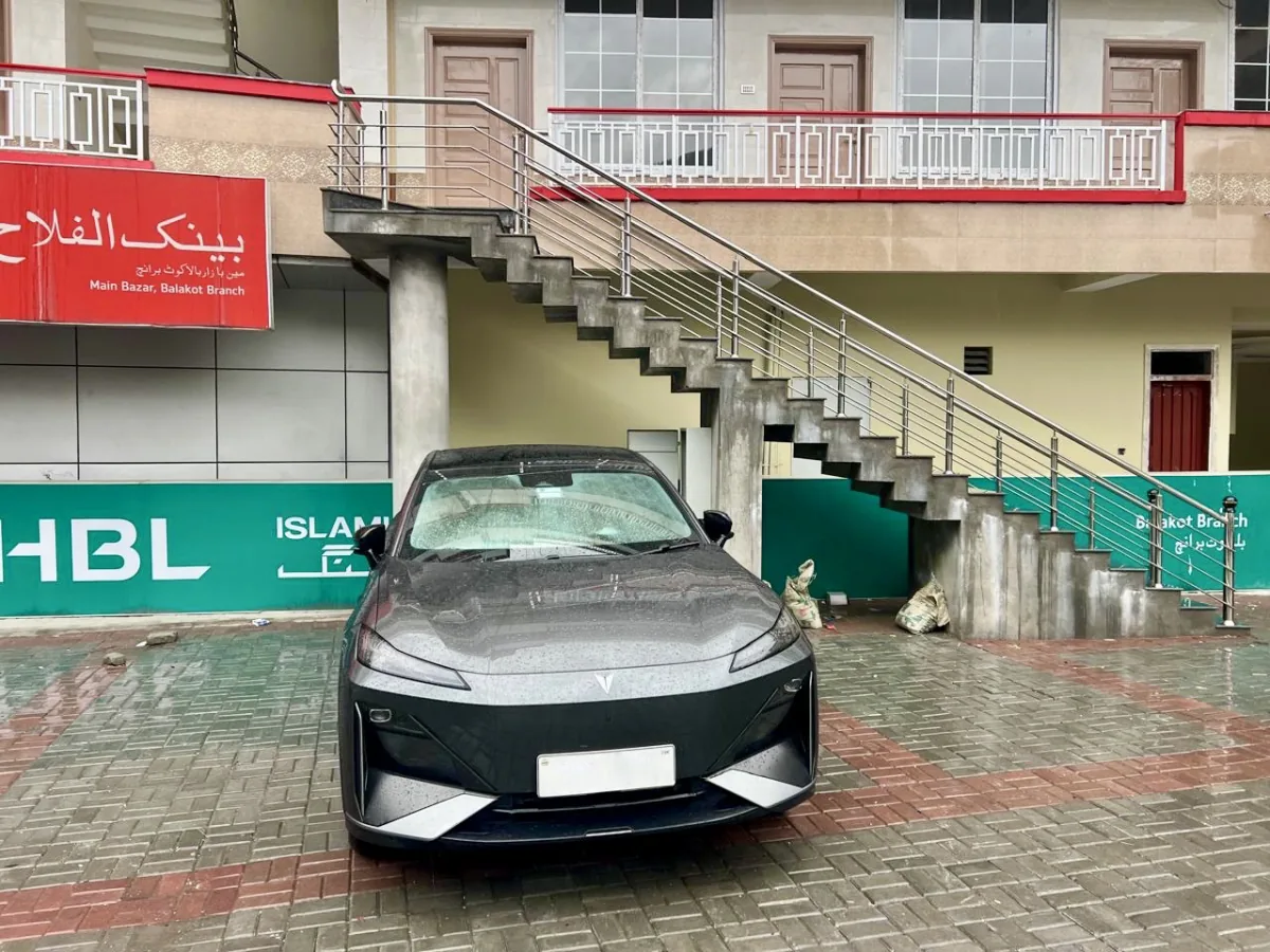 A Deepal S07 electric car parked at the Balakot EV Hub on a rainy day