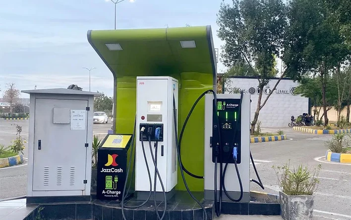 A DC fast charging station under a green canopy at Metro Thokar, Lahore