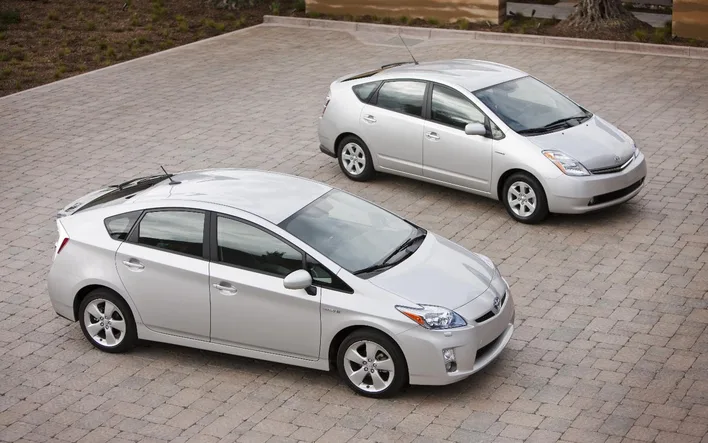 A third generation Toyota Prius parked beside a second generation car